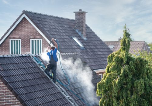 Cleaner,With,Pressure,Washer,At,Roof,Of,House,Cleaning,The